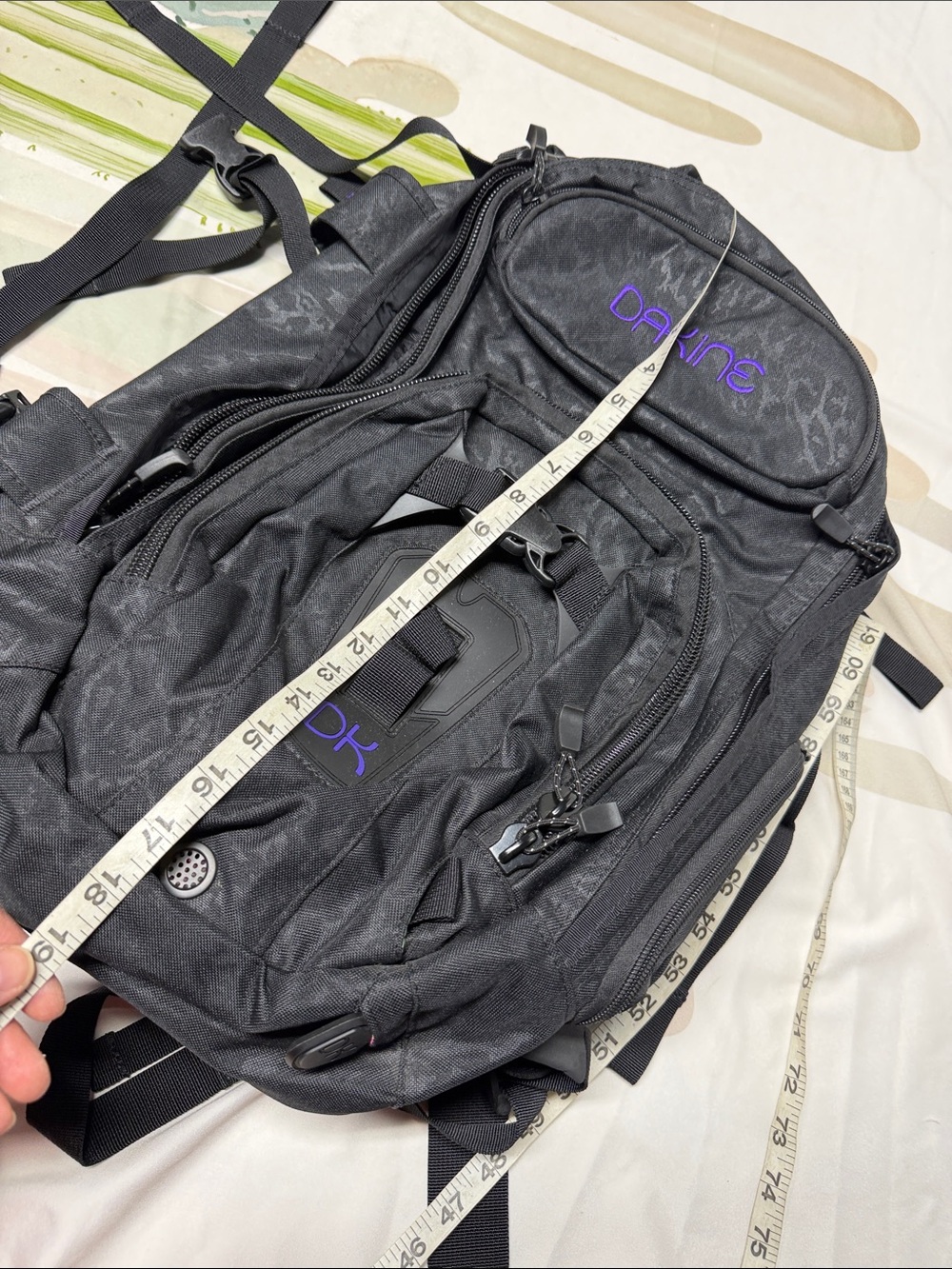 Dakine Heli Pro backpack features a black camouflage pattern and purple brandin - Picture 6 of 6